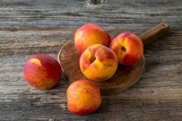 Vivid peaches and nectarines on wood floor