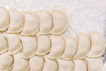Beautiful raw dumplings with variety of fillings. Dumplings production. Top view. High quality photo