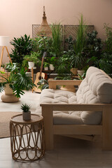 Fototapeta na wymiar Living room interior with stylish furniture and different houseplants
