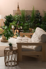 Living room interior with stylish furniture and different houseplants