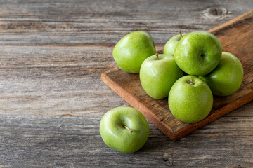 fresh green apple (sour apple) on wood background. Copy space