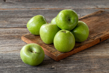 fresh green apple (sour apple) on wood background