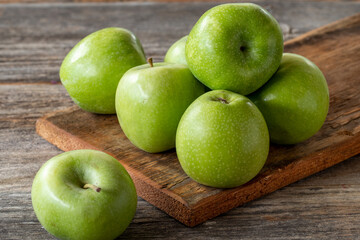 fresh green apple (sour apple) on wood background. Close up
