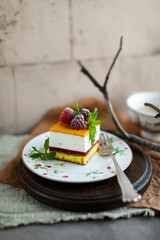 Mousse cake with lemon, raspberry filling and sea buckthorn cream. Summer desserts with seasonal berries.