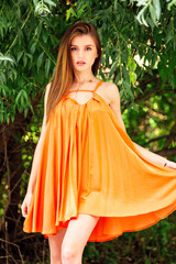 woman with modern orange dress on vacation 