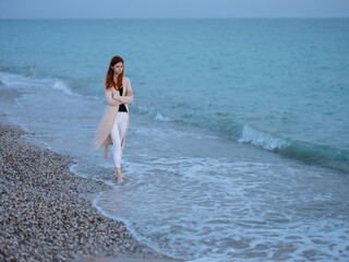 woman walking by the ocean rest freedom romance