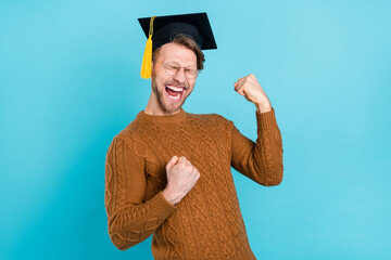 Photo of funny adorable guy dressed knit sweater academic hat spectacles screaming rising fists...