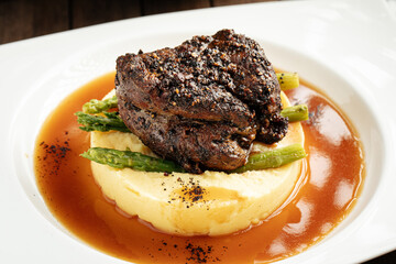 Grilled beef pepper steak with mashed potatoes and asparagus