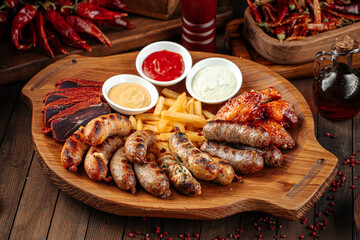 Wooden tray of beer appetizers set assortment with sauces