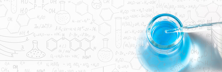Blue science glass tube experiment on white background,Hand drawn science formulas on chalkboard...