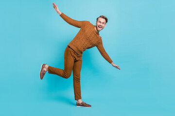 Fototapeta premium Full body photo of charming happy young man dance hands wings smile isolated on blue color background
