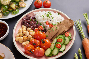 Healthy Organic Tofu and Rice Buddha Bowl with Veggies. Poke bowl with silken tofu, rice and mixed vegetables, carrots, asparagus, tomatoes, beans . Healthy vegetarian salad bowl.