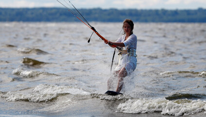 Kite surfer girl glides on waves portrait