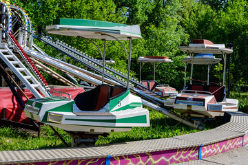 Vivid colorful retro cars at a children playground in a park in a sunny spring day.