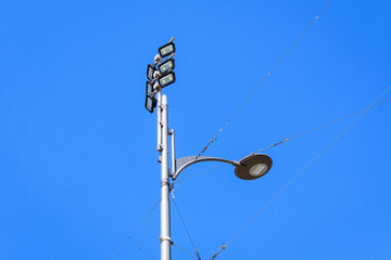 Fototapeta na wymiar Modern economic lighting pole with clear blue sky in the background in Bucharest, Romania.