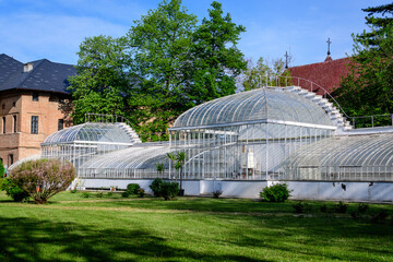Fototapeta na wymiar Old historical buiding of a greenhouse at Mogosoaia Palace (Palatul Mogosoaia) near the lake and park, a weekend attraction close to Bucharest, Romania, in a sunny spring day.