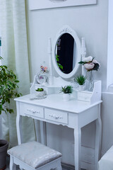 white dressing table for ladies. Place to apply makeup at home. Cozy place for women.