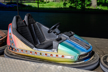 Old colorful electric bumper car in autodrom in the fairground attractions at amusement park.