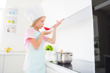 Profile side photo of young preteen girl taste dish yummy saucepan culinary cuisine healthy food...