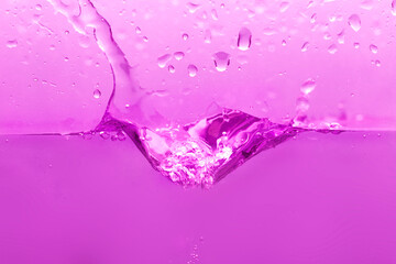 Ice falls and splashes onto the pink water surface. Clear water. Waves move to drink.