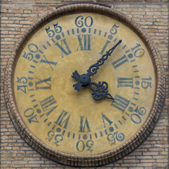 Ancient watch on the wall in PArma, Italy