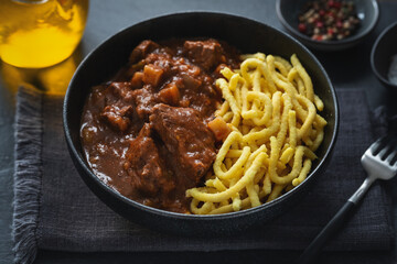 Meat ragout stew with noodles in bowl
