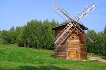 Fototapeta na wymiar An old wooden windmill of the 19th century. Mill for grain processing and flour production.