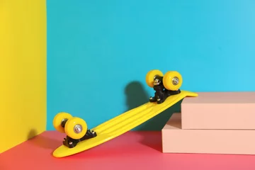 Rollo Yellow skateboard on color background. Space for text © New Africa