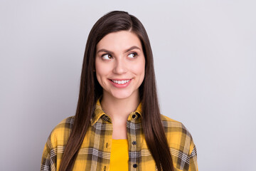 Photo of sweet cute young woman dressed checkered shirt smiling looking empty space isolated grey color background