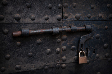 vintage bolt with a lock on a rusty iron door, Italy
