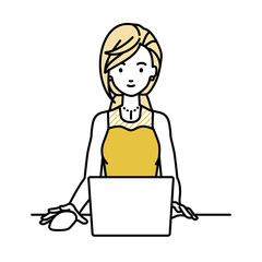 デスクで座ってPCを使っているドレスの女性