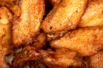 Fried chicken wings on a plate, close-up, selective focus.