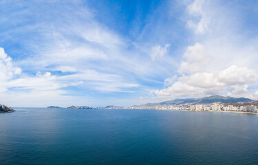 Beautiful view of the beach, aerial view of the sea, acapulco beach seen from above. Travel and vacation concept. Colorful sunset on the beach. Aerial photography.