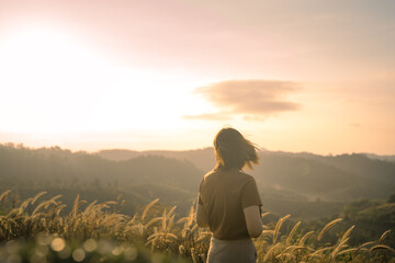 Fototapeta premium solo woman travel take photo and sightseeing sunrise on mountain at thailand
