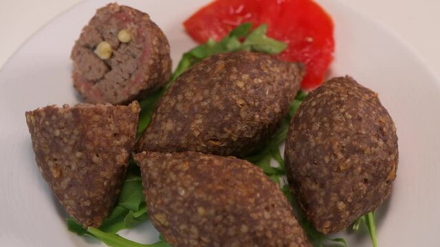 Traditional kebbe on turntable in lebanese restaurant, High quality 4k footage