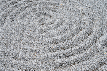 Fototapeta na wymiar Traditional Detail of Classical Japanese Zen Garden white sand with spherical circles