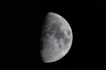 First quarter (half) moon close-up with black universe background - obrazy, fototapety, plakaty