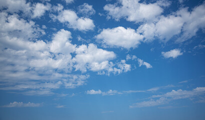 Small clouds in the blue sky.