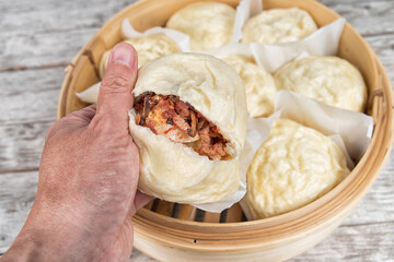 Vietnamese Chinease steamed buns in a bamboo basket