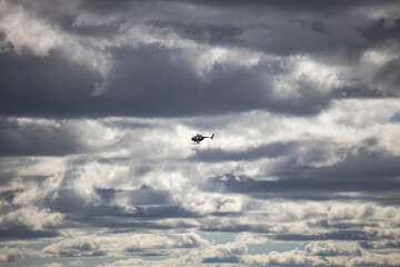 Amazing view of helicopter in cloudy sky. Sweden. 