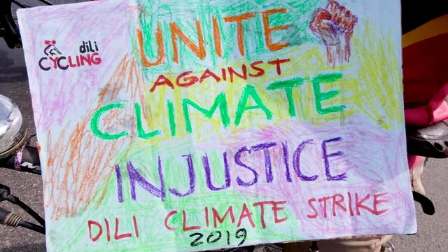 People gathering, marching and unite against climate injustice closeup. Climate change march in capital Dili, Timor Leste, Southeast Asia.