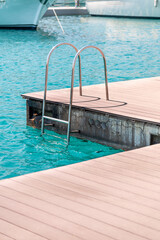 floating dock with composite deck and ladder at the marina.