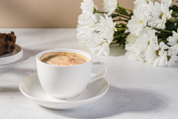 coffee in a mug with milk and cinnamon