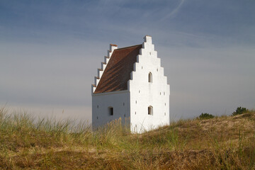 Fototapeta na wymiar White tower in the dunes, the Sand-buried Church, Skagen, Denmark