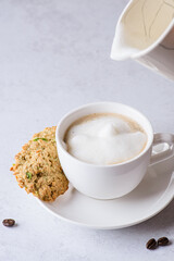 coffee in a mug with milk and cinnamon