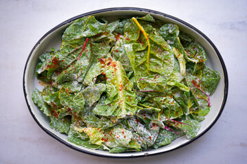 Healthy salad, leaves mix salad with leaves of mangold, arugula, spinach and beets. Vegetarian food. Food background.                          