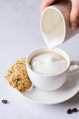 coffee in a mug with milk and cinnamon