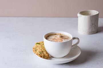 coffee in a mug with milk and cinnamon