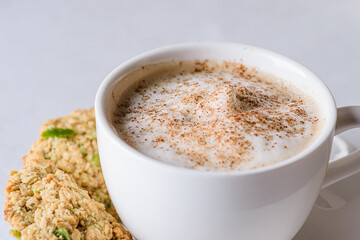 coffee in a mug with milk and cinnamon