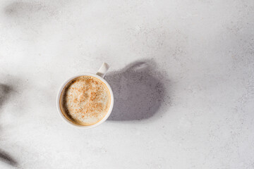 coffee in a mug with milk and cinnamon